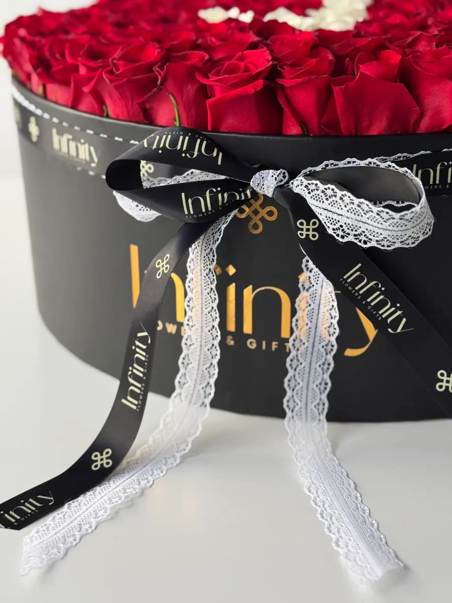 Infinity signature flower box with red and white roses